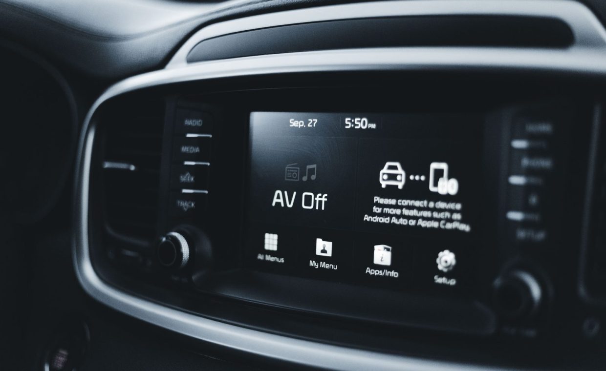 Detailed close-up of a modern car dashboard screen displaying various tech options and settings.