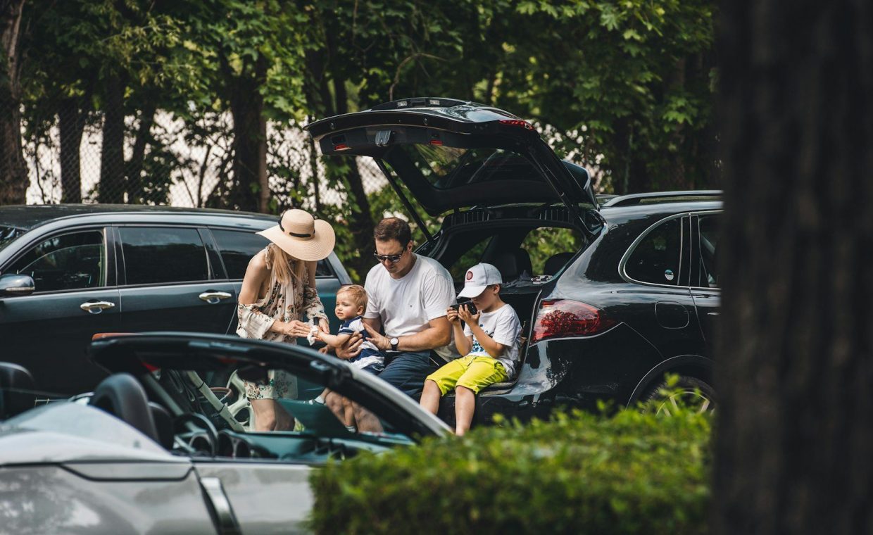 a group of people sitting in the trunk of a car