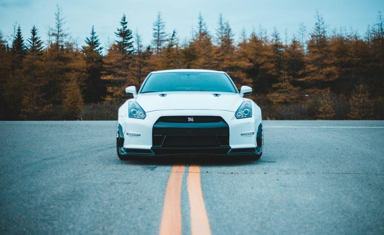 a white car parked on the side of a road
