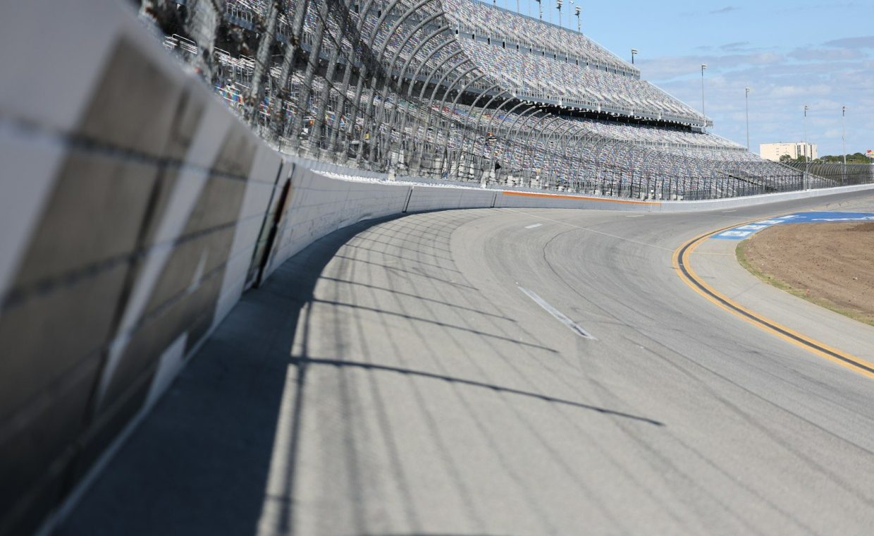 A racetrack curve and grandstands are shown.