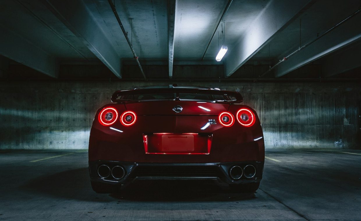 red sports car on concrete flooring